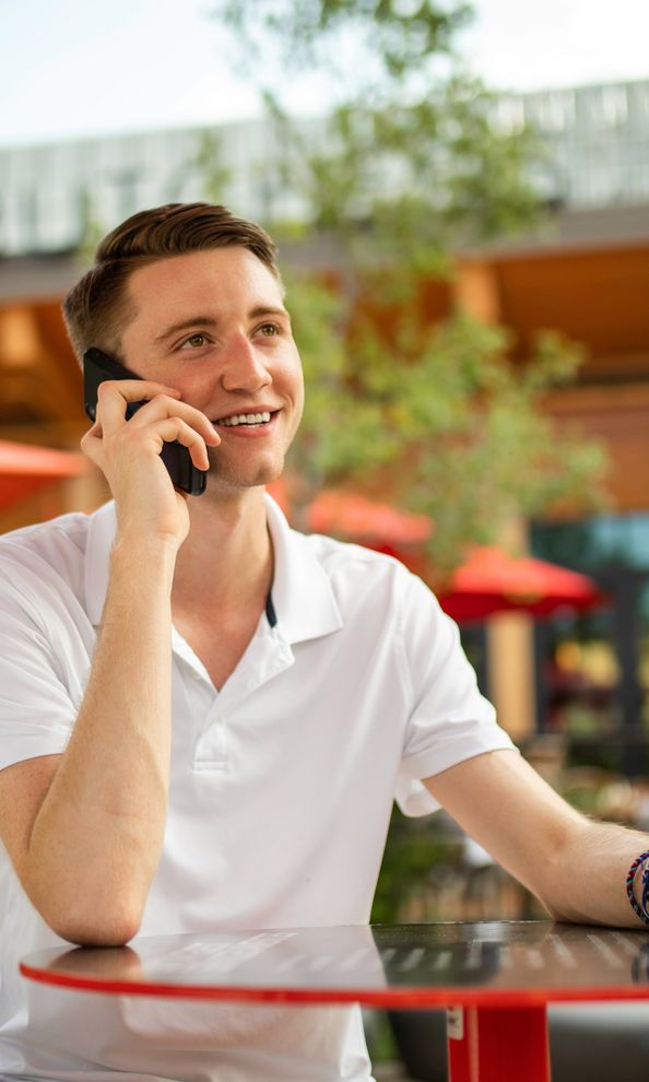 Business professional talking on a phone while working remotely