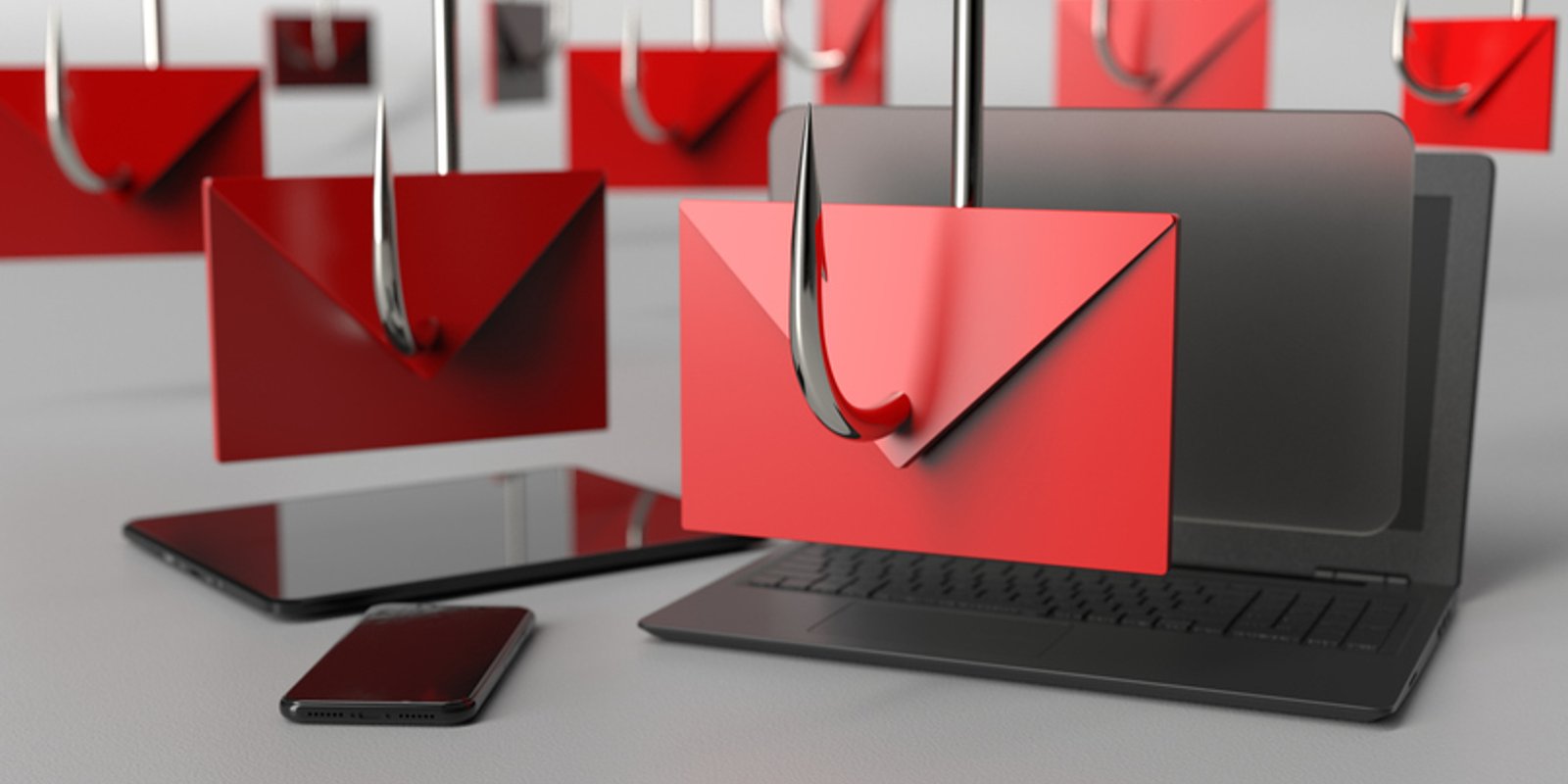 Phishing emails displayed on a laptop and smartphone