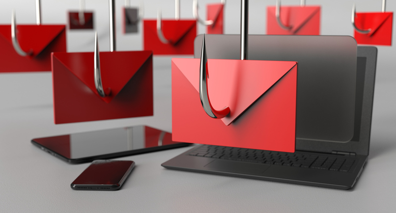 Phishing emails displayed on a laptop and smartphone