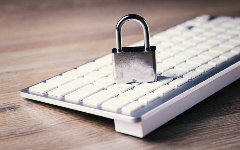 Cybersecurity protection icons over a laptop