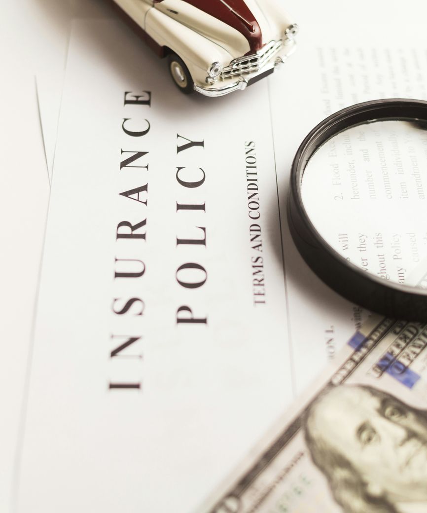 Insurance professional reviewing coverage information at a desk