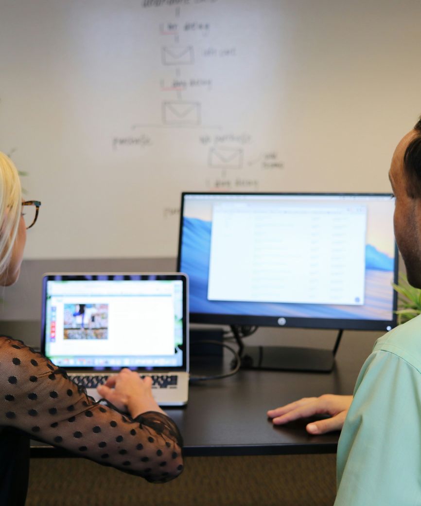 Two colleagues reviewing a computer screen during a support session